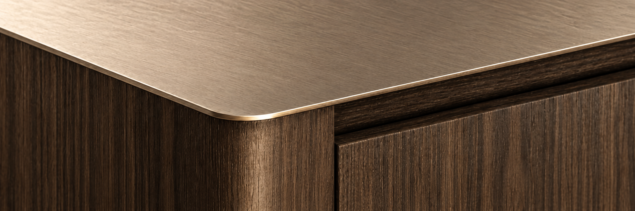 Brushed metal top meeting dark timber joinery at a refined rounded corner